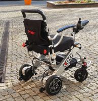 Vorschau: Elektro-Reise-Rollstuhl R-GO (6 km/h) silber, neuwertig Vorschau: Elektro-Reise-Rollstuhl R-GO (6 km/h) silber, neuwertig